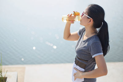 Close-up of woman drinking water from bottle