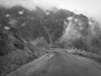 Road amidst snow covered mountains