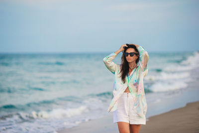 Young woman standing at beach