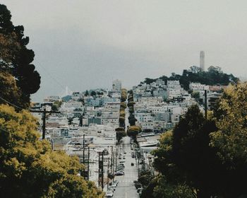 Buildings in city against clear sky