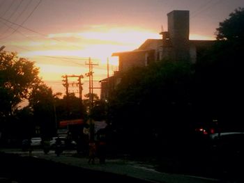 Buildings in city at sunset