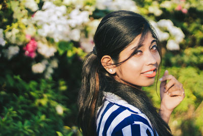 Portrait of beautiful young woman looking away