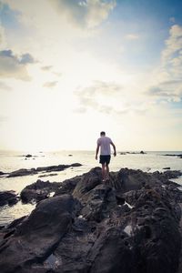 Rear view of a man walking on beach