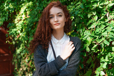 Portrait young tender red haired young girl with healthy freckled skin in white