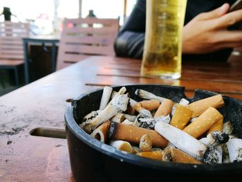 Close-up of cigarette smoking on table