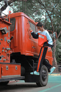 Side view of man working in bus