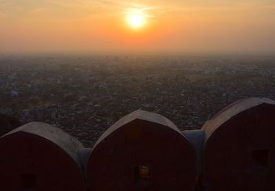 Aerial view of cityscape against sky during sunset