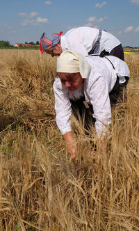 Full length of man wearing hat on field against sky