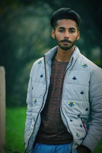 Portrait of young man standing outdoors