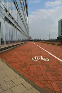 Close-up of road against cloudy sky