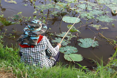 High angle view of woman fishing in lake