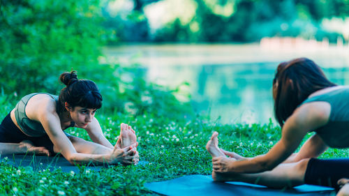 Mindfulness and meditation. women doing yoga by the lake