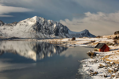 View of lake against mountain range during winter