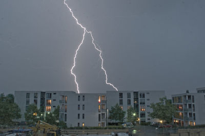 Lightning over city against sky at night