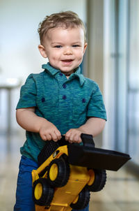 Portrait of cute boy holding toy