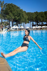 Young woman swimming in pool