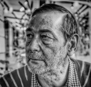 Close-up of bearded senior man at home