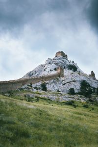 Low angle view of castle on field against sky