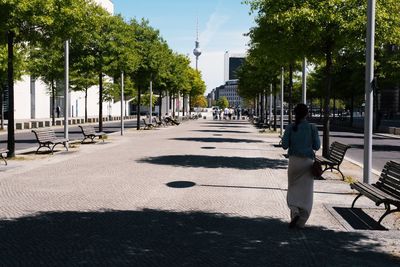 Rear view of woman walking on street in city