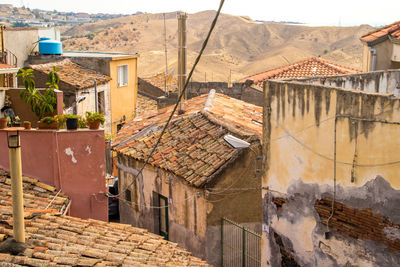 High angle view of houses in town against sky