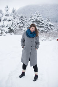 Portrait of man standing on snow covered landscape