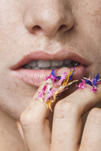 Cropped image of young woman holding colorful petals