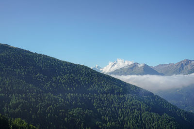 Scenic view of mountains against clear blue sky