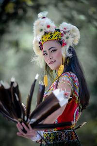 Portrait of young woman in traditional clothing standing outdoors
