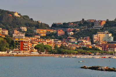 Town by sea against clear sky