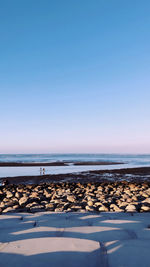 Scenic view of sea against clear blue sky