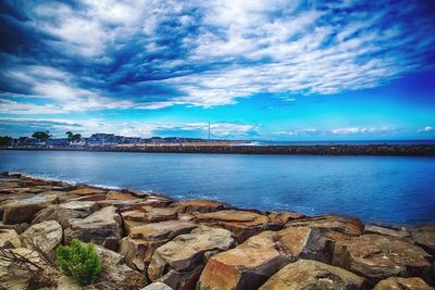 Scenic view of sea against cloudy sky