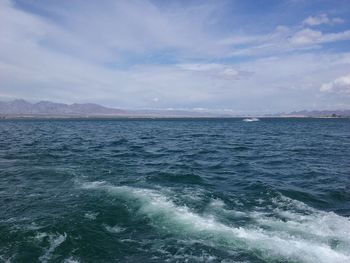 Scenic view of sea against cloudy sky