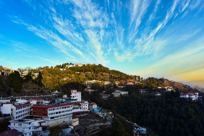 High angle view of townscape on mountain against blue sky