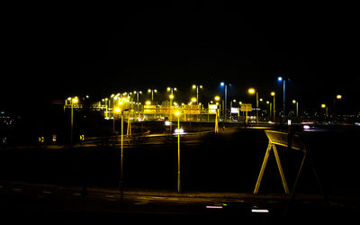 Illuminated city against sky at night