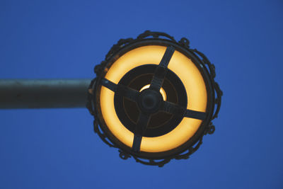 Low angle view of yellow water against clear blue sky
