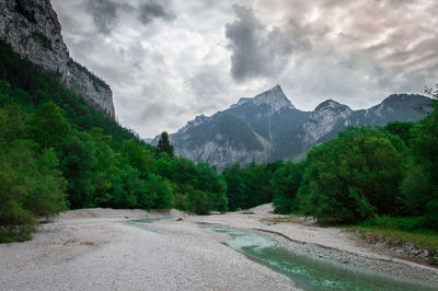 Scenic view of road by mountains against sky