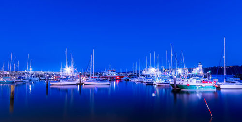 Boats moored at harbor