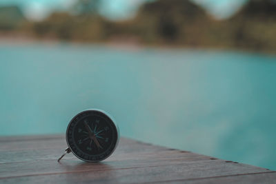 Close-up of black tea on table by swimming pool