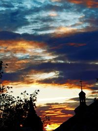 Low angle view of silhouette building against sky during sunset