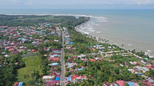High angle view of trees and buildings against sea at sumatera