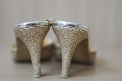 Close-up of high heels and ring on floor at home