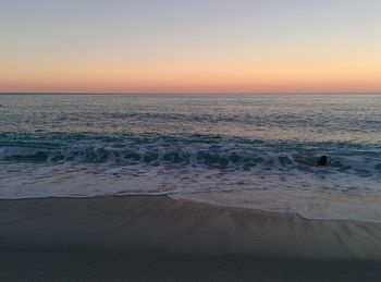 Scenic view of sea against clear sky during sunset