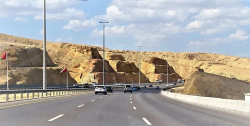 Cars on highway against sky