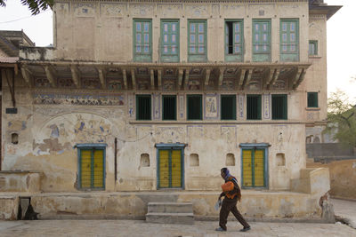 Full length of man standing outside building