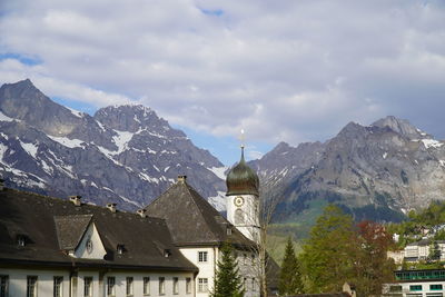 Panoramic view of buildings and mountains against sky