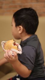 Midsection of boy eating ice cream