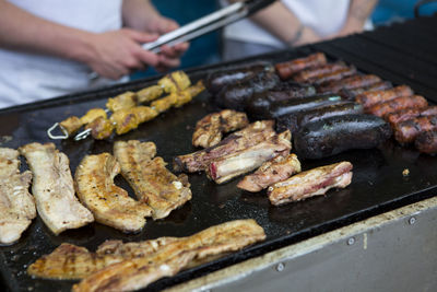 Cropped image of people preparing meat