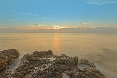 Scenic view of sea against sky during sunset