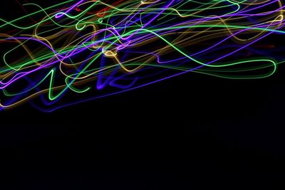 Close-up of light trails over black background