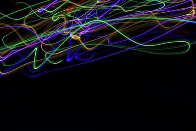 Close-up of light trails over black background